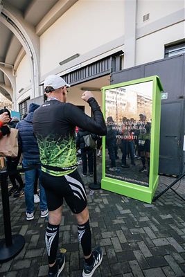 Hyundai mechanic inspecting the underside of a vehicle near the tire.
