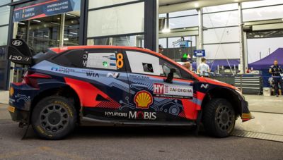 The Hyundai i20 N WRC rally race car parked at the Hyundai pitstop.