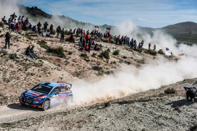 Hyundai Motorsport customer racing rally car i20 R5 in action on a gravel mountain road.