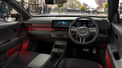 The sporty interior of the KONA N Line with red accents and ambient lighting.