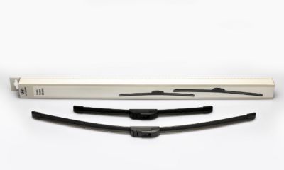 Hyundai i20 driving through a city street with buildings in the background.