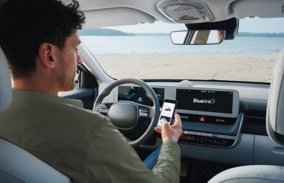 Driver using Hyundai Bluelink® before he starts his journey