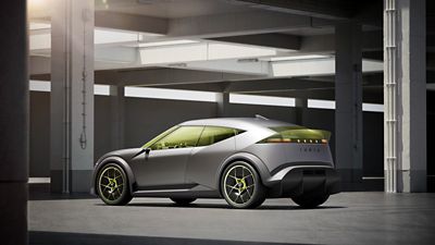 Hyundai Concept THREE in a parking garage, featuring a matte gray finish, yellow-green windows, and neon-accented wheels.