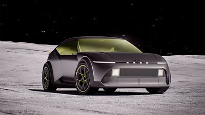 Hyundai Concept THREE on a moon-like surface under a starry sky, featuring a sleek design.