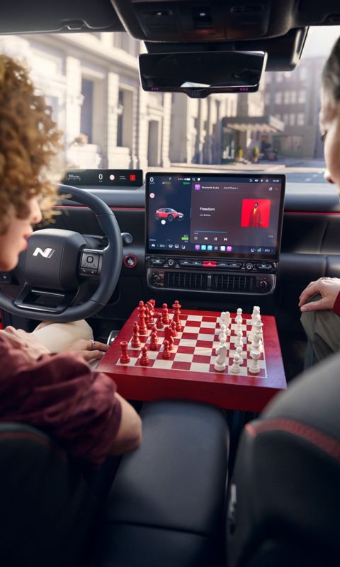 Hyundai IONIQ 3 interior centre console with a wooden chessboard between the front seats.