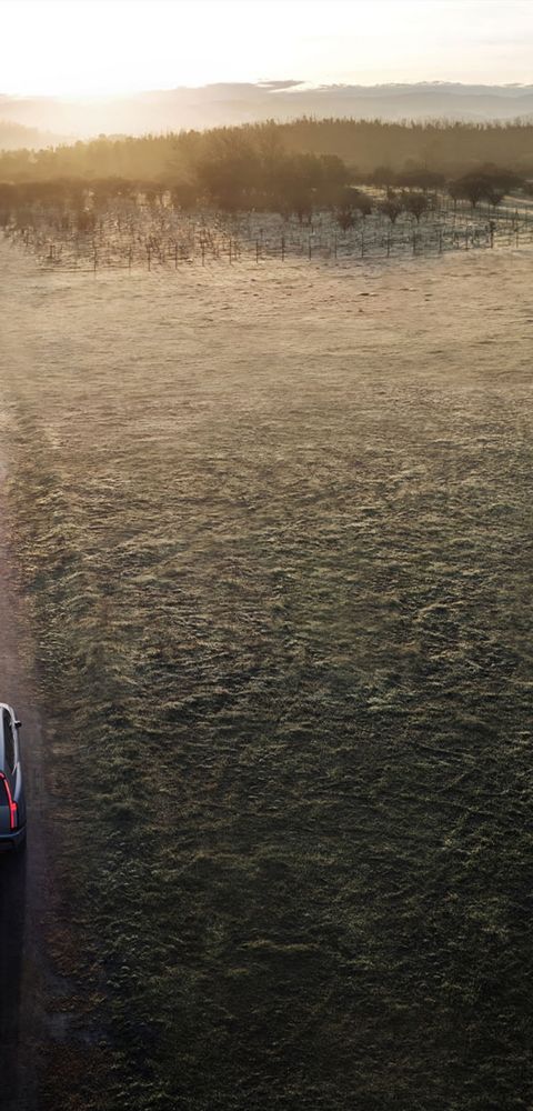 Hyundai IONIQ 9 electric SUV driving down a dirt road seen from above.