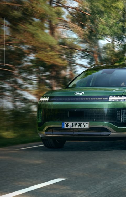 A Hyundai IONIQ 9 on a forest road with EURO NCAP badge showing 5-star rating.