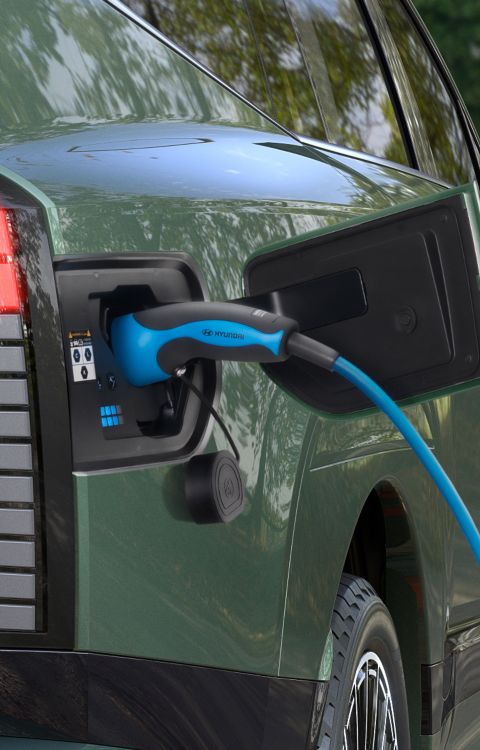 The open charging socket of Hyundai IONIQ 9 electric SUV with charging cable.