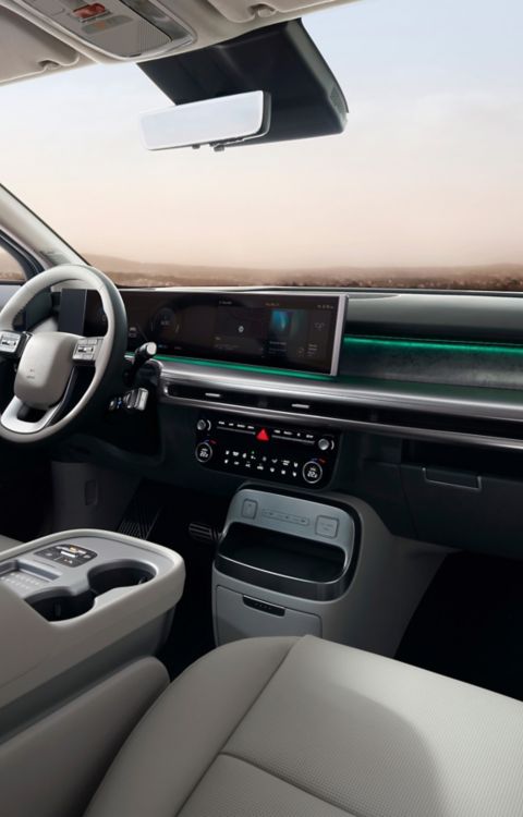 Interior of the Hyundai IONIQ 9 cockpit showing the integrated displays and both front seats.