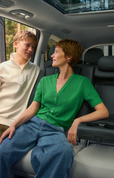 Spacious rear seating area in Hyundai IONIQ 9 with passenger and open cabin view