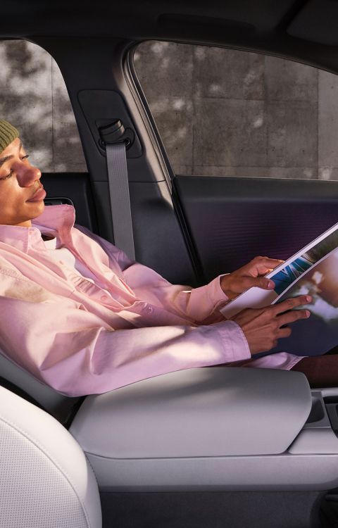 Man reclining in the front row relaxation seat in the Hyundai IONIQ 6 all-electric sedan.