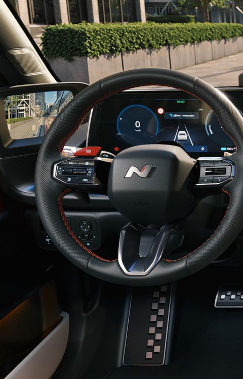 Leather N Line steering wheel inside a Hyundai IONIQ 6 N Line electric sedan.
