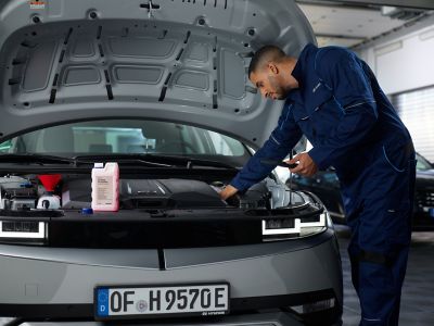 Car mechanic inspects the car in the workshop.